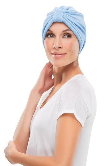 Model with hair loss is covering her head in a blue Terry Turban by Jon Renau